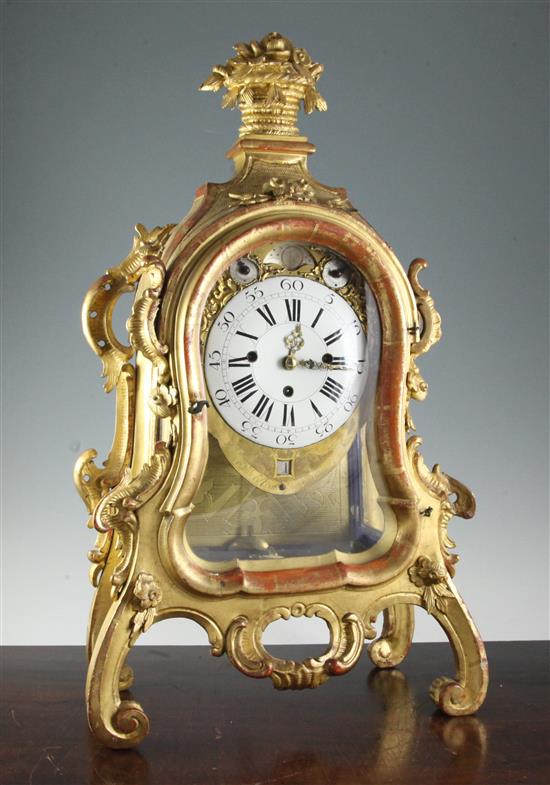 A mid 18th century German carved giltwood striking and chiming mantel clock, 26in.